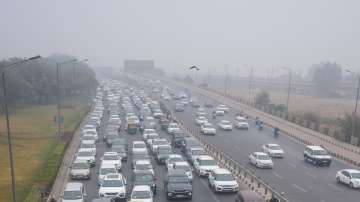 Vehicles stuck in traffic jam on a road amid low visibility due to fog on a cold winter morning, in New Delhi. (Representational image)