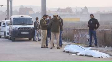 Police stand near the Bhalswa drain where a chopped body was reportedly found in New Delhi on Saturday. 