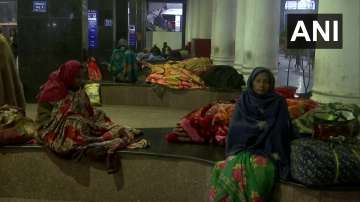 Passengers wait for trains at the New Delhi Railway Station. 