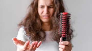 Women looking at her damaged hair