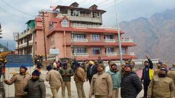 Police officials inspect a hotel in Joshimath