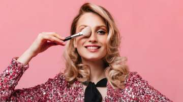 Representative image of a woman applying makeup with a brush