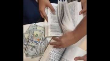 Mumbai Airport customs intercepted two foreign nationals in two separate cases and seized USD 90,000 concealed in pages of books.