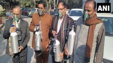 BJP MLAs attend Delhi assembly meeting wearing oxygen masks and cylinders. 