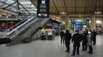 Police officers secure the access to Eurostar trains linking France to Britain, at the Gare du Nord railway station in Paris amid a knife attack.