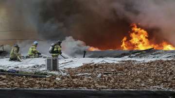 Firefighters battle a fire at Guryong village in Seoul, South Korea. 