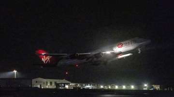 A repurposed Virgin Atlantic Boeing 747 aircraft, named Cosmic Girl, carrying Virgin Orbit's LauncherOne rocket, takes off from Spaceport Cornwall at Cornwall Airport, Newquay, England. 