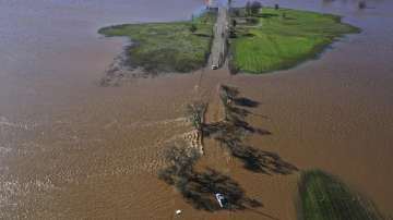 Vehicles are submerged on Dillard Road west of Highway 99 in south Sacramento County in Wilton, California, Sunday, January 1, 2023, after heavy rains on New Year's Eve. 