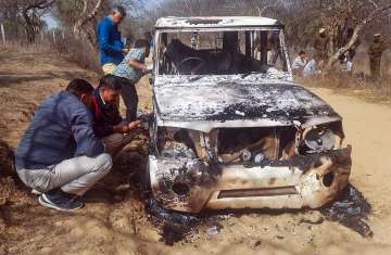 Charred remains of a vehicle where bodies of two Muslim men were found, at Loharu in Bhiwani district.
