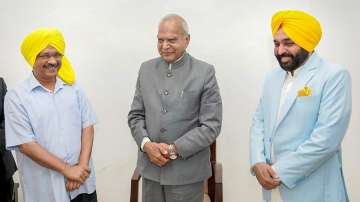 AAP leader Bhagwant Mann with Delhi Chief Minister and AAP Convener Arvind Kejriwal and Punjab Governor Banwarilal Purohit.