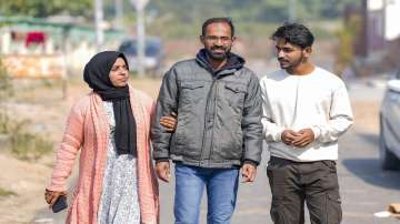 Journalist Siddique Kappan with his wife Raihana and son Muzammil following his release from jail 