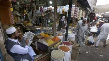 People visit a market to buy produce and other items in Peshawar, Pakistan.