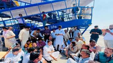 Congress leaders protest on the airport tarmac