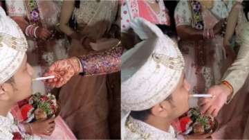 Bride's parents welcome groom with cigarette and paan