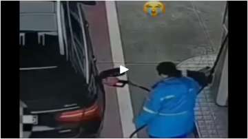 Female worker filling fuel in car.