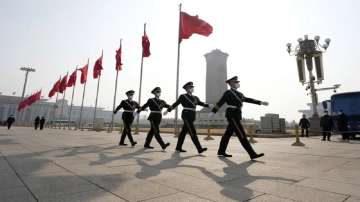 Chinese paramilitary policemen march across Tiananmen Square near the Great Hall.