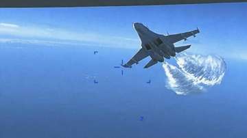 A Russian Su-27 approaches the back of the MQ-9 drone and begins to release fuel as it passes, over the Black Sea.