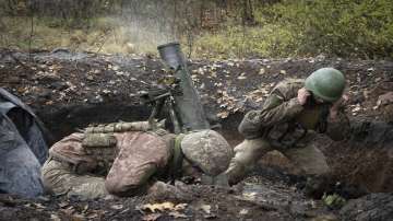 Ukrainian soldiers fire a mortar in the front line near Bakhmut.