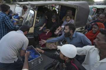 People collecting food packets in Pakistan 