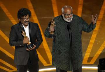 M.M. Keeravaani, right, and Chandrabose accept the award for best original song for "Naatu Naatu" from "RRR" at the Oscars on Sunday, March 12, 2023, at the Dolby Theatre in Los Angeles. 