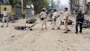 Police personnel attempt to maintain law and order after clashes broke out between two groups during a procession a day after Ram Navami, in Nalanda district,