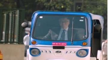 Microsoft co-founder Bill Gates drives electric 3-wheeler auto rickshaw in India.