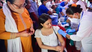 A healthcare worker administers a booster shot of Covid-19 vaccine to a beneficiary on the first day of a 75-day special drive for free vaccination against Covid-19, in Guwahati.