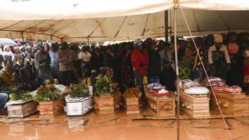 People attend the burial ceremony of some of the people who lost their lives following heavy rains caused by Cyclone Freddy in Blantyre, southern Malawi.