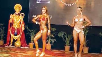 Bikini-clad women pose before Lord Hanuman idol