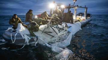 This image provided by the U.S. Navy shows sailors assigned to Explosive Ordnance Disposal Group 2 recovering a high-altitude surveillance balloon off the coast of Myrtle Beach.