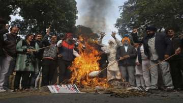 Sikh protestors burn effigies of congress party leaders Sajjan Kumar and Kamal Nath during a protest in New Delhi.