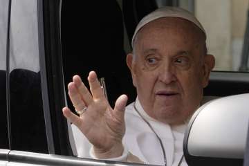 Pope Francis waves from his car as he leaves the Agostino Gemelli University Hospital in Rome