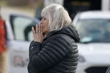 A woman reacts at the scene of a multiple shooting.