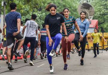 Wrestlers Vinesh Phogat, Sangita Phogat and Sakshi Malik exercise at Jantar Mantar during their protest