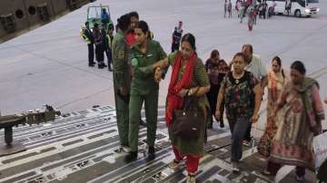 Indian Air Force’s Flight Lieutenant Har Raj Kaur Boparai helps a lady to board the aircraft in Jeddah.