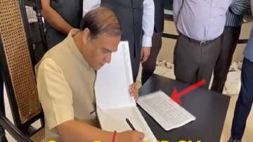  Assam CM Himanta while filling in details in a visitor's book