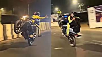 Man performs dangerous bike stunt with two women