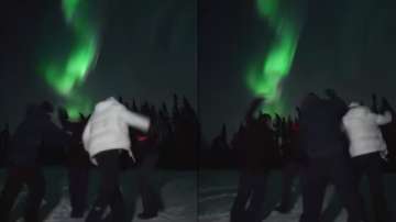 Men perform garba under Northern Lights