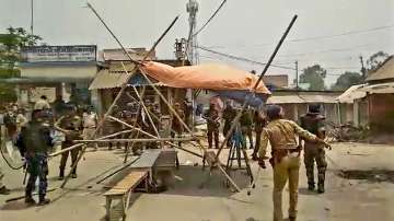 Security personnel try to control the situation after violent protests against the death of a minor girl, in North Dinajpur district of West Bengal.