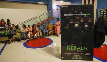 Women wait at a cinema hall to watch the The Kerala Story film