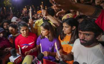 Wrestlers Sakshi Malik, Vinesh Phogat, Sangeeta Phogat and Bajrang Punia light candles during their protest at Jantar Mantar