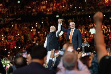 Crowd cheer as Prime Minister Narendra Modi arrives with Australian counterpart at a community programme
