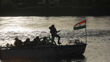Border Security Force (BSF) soldiers patrol on a boat in the Chenab river amid a high alert in view of the upcoming G20 meeting in J&Ks Srinagar.