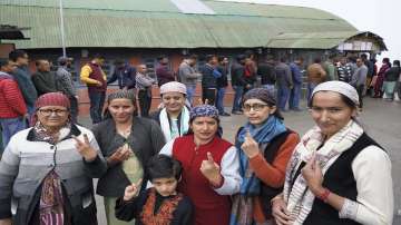 Voters pose for photos showing their fingers marked with indelible ink after casting their votes for the Himachal Pradesh Municipal Corporation elections, in Shimla.