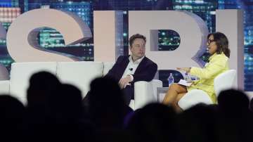 Twitter CEO Elon Musk, center, speaks with Linda Yaccarino, chairman of global advertising and partnerships for NBC, at the POSSIBLE marketing conference, Tuesday, April 18, 2023, in Miami Beach.