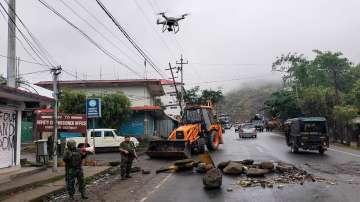 Army personnel stand guard and use a drone for combing operation in the aftermath of recent spurt in violence, in Manipur.