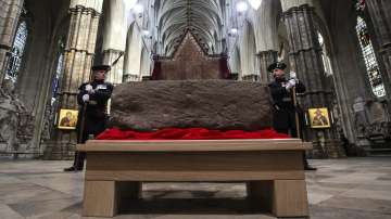 King's Bodyguards for Scotland and members of Royal Company of Archers Alex Baillie-Hamilton, left, and Paul Harkness stand guard by the Stone of Destiny, during a welcome ceremony in Westminster Abbey, London.