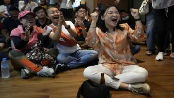 Supporters of Move Forward party cheer as they watch counting of votes on television at Move Forward Party headquarters in Bangkok, Thailand.