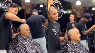 Barber shaves own head along with mother’s in support of her cancer battle.