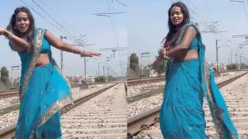 Woman wearing saree dances on railway tracks